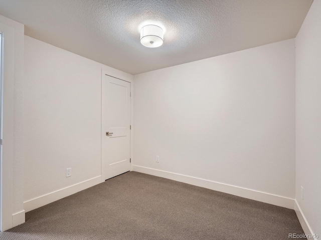 carpeted spare room with a textured ceiling