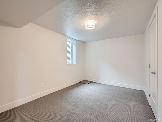 unfurnished room featuring carpet and a textured ceiling