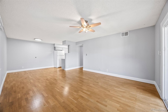 7495 E Quincy Ave Unit 208, Denver, CO 80237 - unfurnished living room with a ceiling fan, light wood-style floors, and a textured ceiling