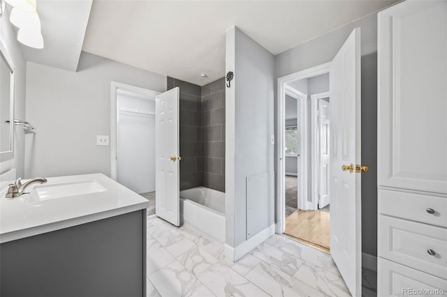 7495 E Quincy Ave Unit 208, Denver, CO 80237 - full bathroom featuring vanity, marble look tiles, and washtub / shower combination