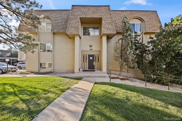 7495 E Quincy Ave Unit 208, Denver, CO 80237 - view of front facade with mansard roof, a shingled roof, and stucco siding