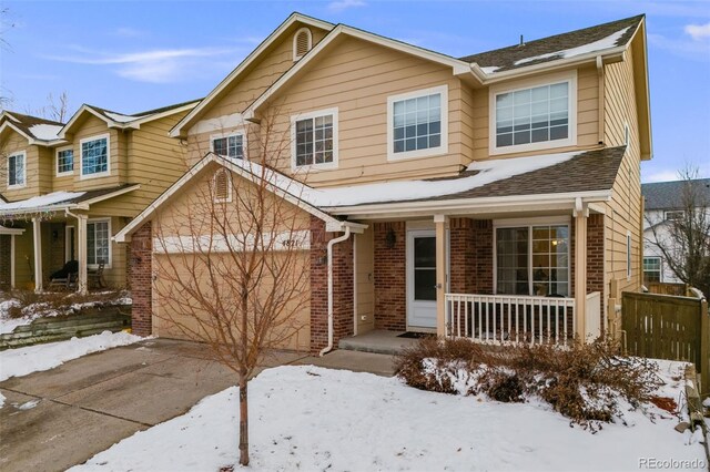 4821 N Silverlace Dr, Castle Rock, CO 80109 - view of front facade with concrete driveway, a porch, and brick siding