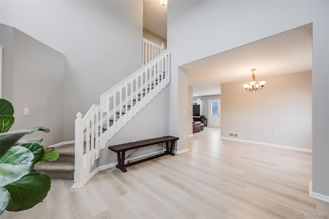 4821 N Silverlace Dr, Castle Rock, CO 80109 - stairs featuring a high ceiling, a notable chandelier, baseboards, wood finished floors, and visible vents