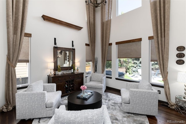 3791 Charterwood Cir, Highlands Ranch, CO 80126 - living room featuring a towering ceiling, plenty of natural light, and wood finished floors
