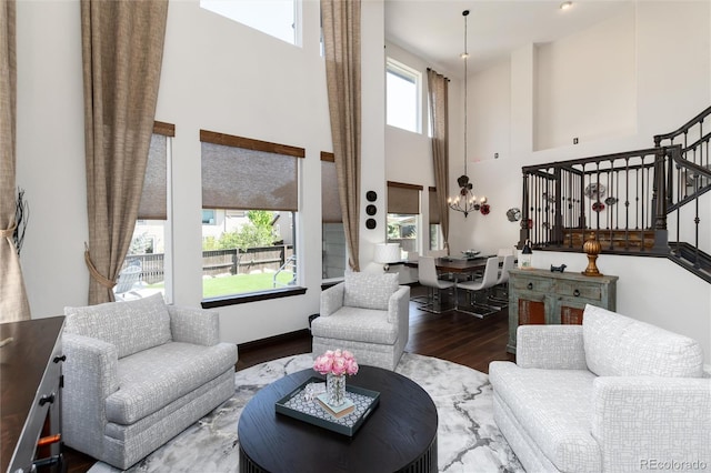 3791 Charterwood Cir, Highlands Ranch, CO 80126 - living area with a high ceiling, a chandelier, wood finished floors, and stairway