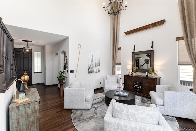 3791 Charterwood Cir, Highlands Ranch, CO 80126 - living area with dark wood-style flooring, a chandelier, a high ceiling, and baseboards