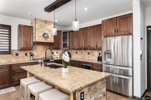 3791 Charterwood Cir, Highlands Ranch, CO 80126 - kitchen with stainless steel refrigerator with ice dispenser, light stone countertops, decorative backsplash, pendant lighting, and recessed lighting