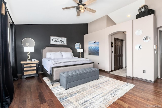 3791 Charterwood Cir, Highlands Ranch, CO 80126 - bedroom with an accent wall, lofted ceiling, arched walkways, wood finished floors, and baseboards