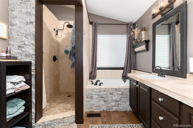 3791 Charterwood Cir, Highlands Ranch, CO 80126 - bathroom featuring wood finished floors, a garden tub, vanity, lofted ceiling, and tiled shower