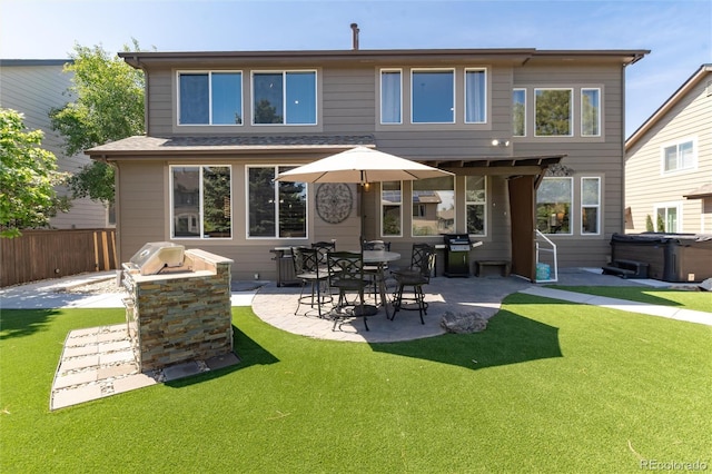 3791 Charterwood Cir, Highlands Ranch, CO 80126 - rear view of property with a hot tub and a patio area