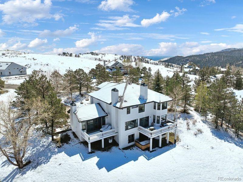 snowy aerial view with a mountain view