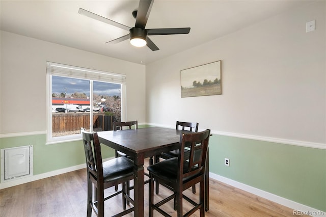 dining area with hardwood / wood-style floors and ceiling fan