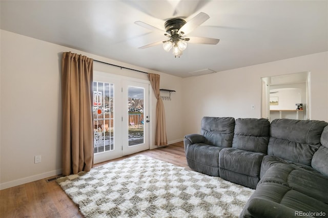 living room with ceiling fan and light hardwood / wood-style floors