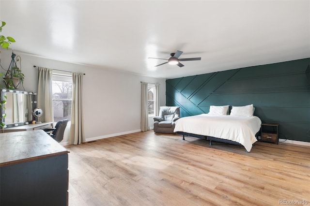 bedroom with light hardwood / wood-style floors and ceiling fan