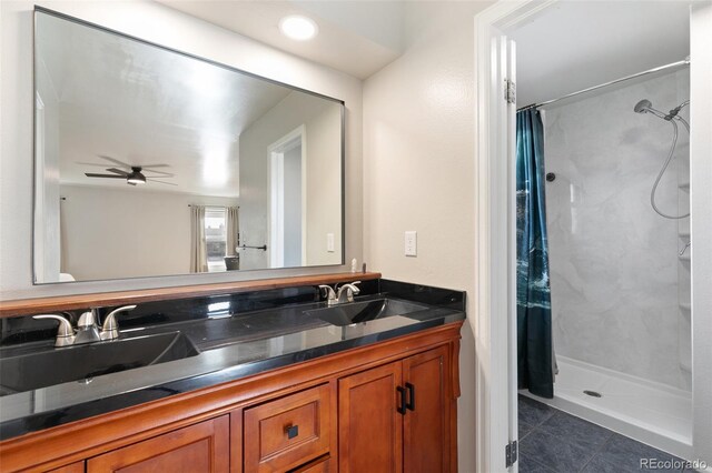 bathroom featuring tile patterned floors, ceiling fan, curtained shower, and vanity