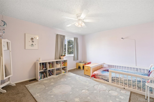 carpeted bedroom with ceiling fan and a textured ceiling