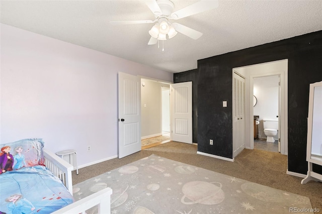 carpeted bedroom with a textured ceiling, ceiling fan, and ensuite bathroom