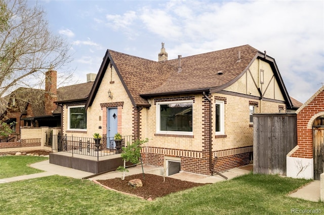 4828 W 32nd Ave, Denver, CO 80212 - back of house featuring a chimney, a lawn, brick siding, fence, and a shingled roof