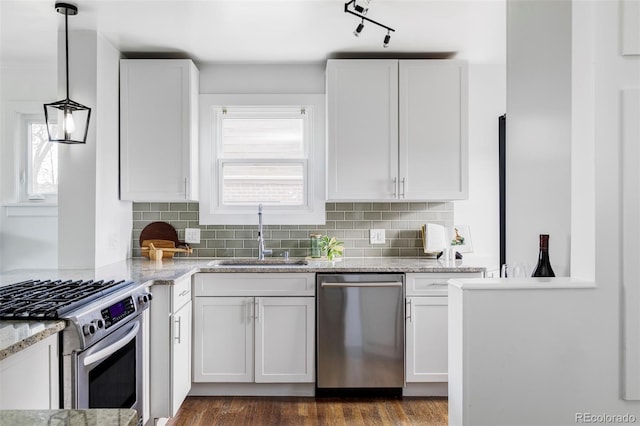 4828 W 32nd Ave, Denver, CO 80212 - kitchen with a sink, stainless steel appliances, white cabinetry, and tasteful backsplash