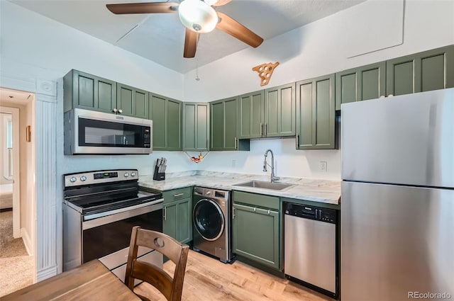 3127 W 28th Ave Unit 2, Denver, CO 80211 - kitchen featuring washer / clothes dryer, ceiling fan, green cabinetry, a sink, and appliances with stainless steel finishes