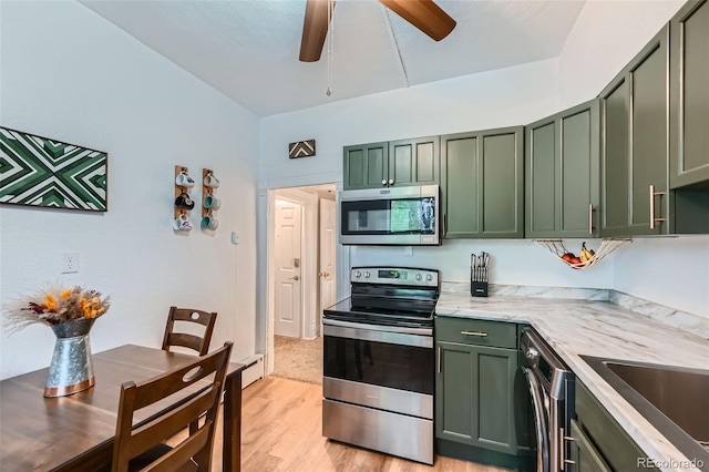 3127 W 28th Ave Unit 2, Denver, CO 80211 - kitchen with light wood-style floors, light stone counters, a ceiling fan, green cabinets, and stainless steel appliances