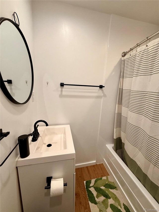 3127 W 28th Ave Unit 2, Denver, CO 80211 - bathroom featuring vanity, wood finished floors, and shower / tub combo
