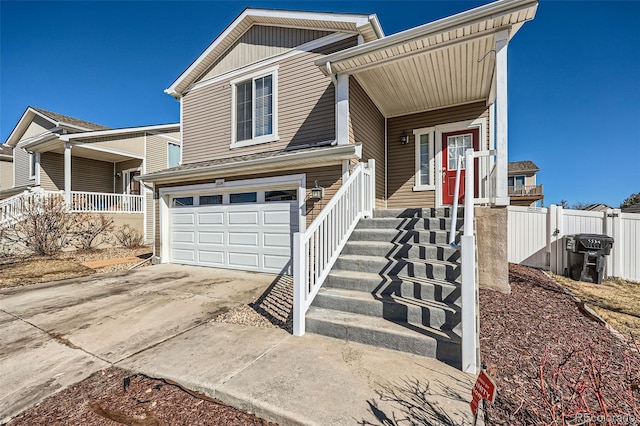 5534 Killarney St, Denver, CO 80249 - view of front of home featuring a porch, fence, an attached garage, and driveway