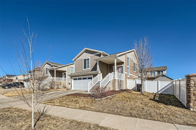 5534 Killarney St, Denver, CO 80249 - view of front of property featuring a porch, an attached garage, fence, and driveway