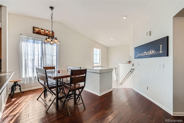 5534 Killarney St, Denver, CO 80249 - dining room with an inviting chandelier, baseboards, lofted ceiling, and dark wood-style floors