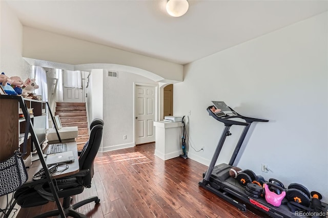 5534 Killarney St, Denver, CO 80249 - office space featuring visible vents, arched walkways, dark wood finished floors, and baseboards