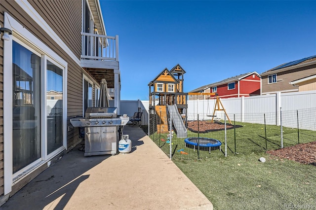 5534 Killarney St, Denver, CO 80249 - exterior space with a fenced backyard, a playground, and a grill
