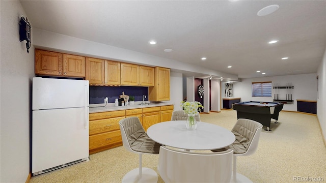 kitchen featuring recessed lighting, pool table, a sink, light countertops, and freestanding refrigerator