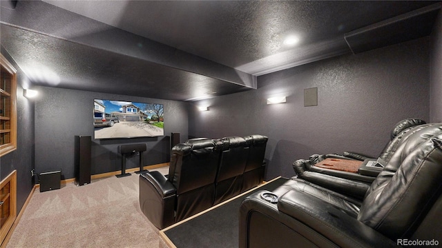 cinema room featuring carpet floors, baseboards, a textured ceiling, and a textured wall