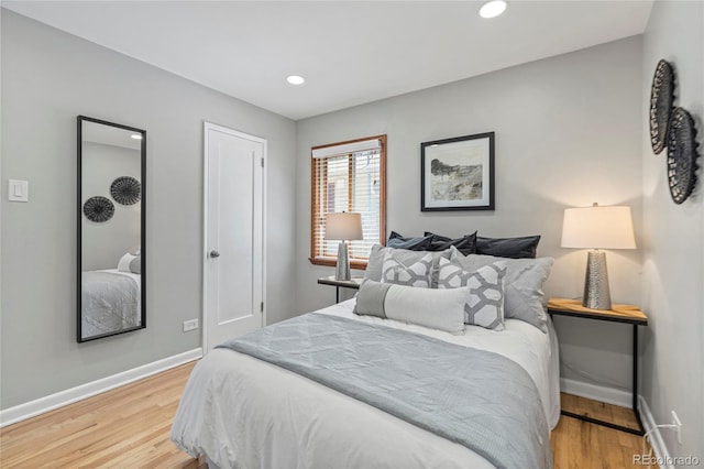 bedroom with hardwood / wood-style flooring