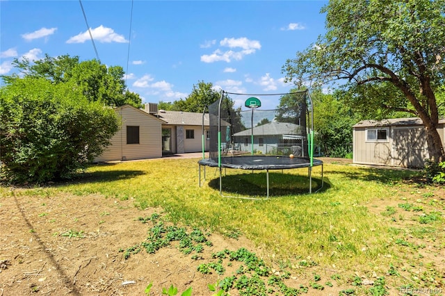 view of yard featuring a storage unit and a trampoline