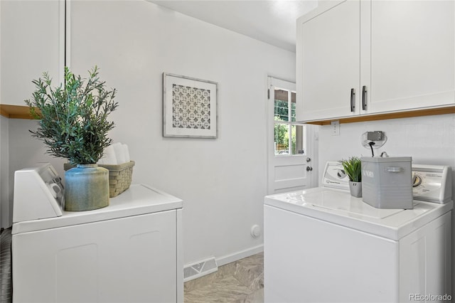 laundry room featuring cabinets and washing machine and clothes dryer