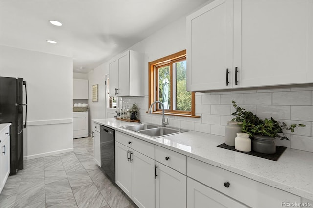 kitchen with washer / dryer, sink, black appliances, white cabinets, and light stone counters