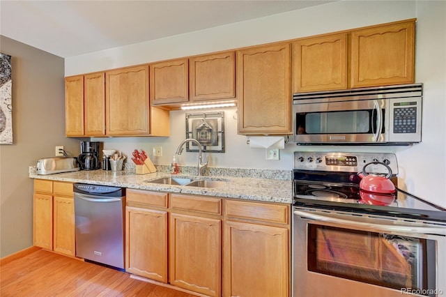 7261 S Colorado Ct, Centennial, CO 80122 - kitchen with stainless steel appliances, light wood-style flooring, and light stone counters
