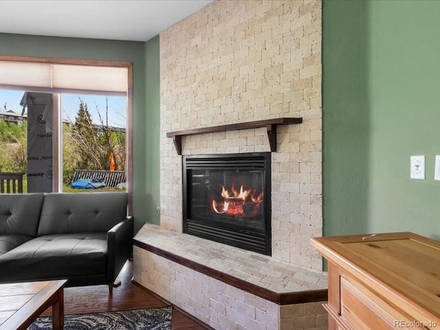 10000 Ryan Gulch Rd Unit 116, Silverthorne, CO 80498 - living room with a fireplace, healthy amount of natural light, and wood finished floors