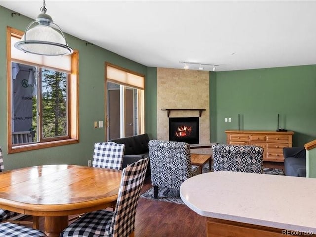 10000 Ryan Gulch Rd Unit 116, Silverthorne, CO 80498 - dining area with a fireplace, track lighting, and wood finished floors