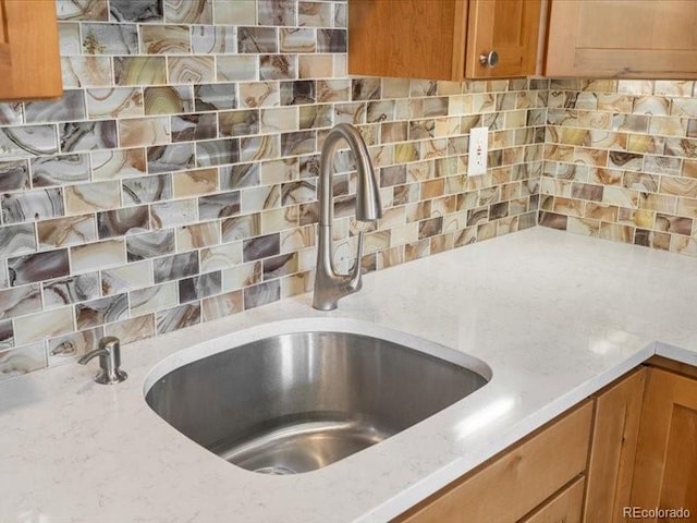 10000 Ryan Gulch Rd Unit 116, Silverthorne, CO 80498 - kitchen view of backsplash, light stone countertops, and brown cabinetry