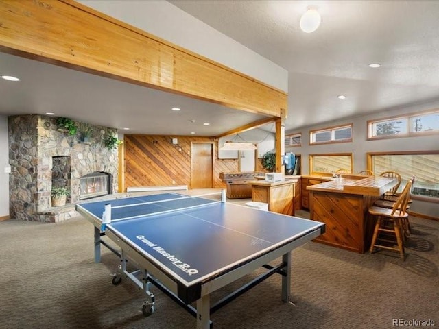 10000 Ryan Gulch Rd Unit 116, Silverthorne, CO 80498 - rec room featuring carpet floors, wooden walls, and a fireplace