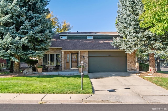 view of front facade with a front yard and a garage