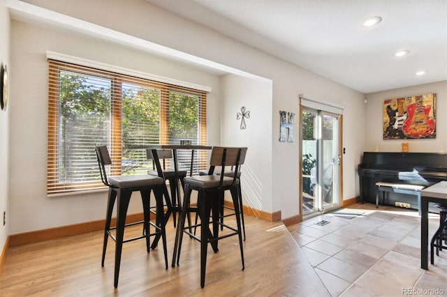 dining area with light wood-type flooring and a wealth of natural light