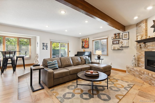 living room with a brick fireplace and beam ceiling