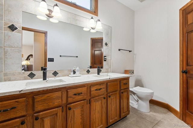 bathroom featuring toilet, tile patterned floors, and vanity