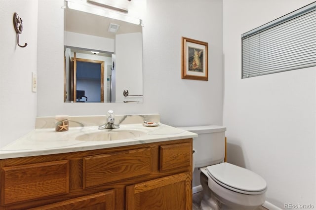 bathroom featuring toilet and vanity