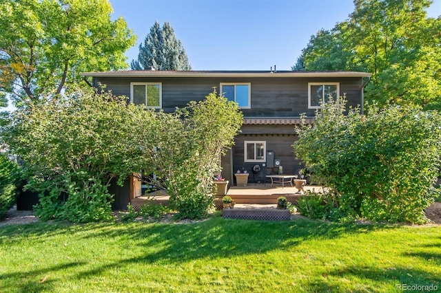 back of house with a yard and a wooden deck