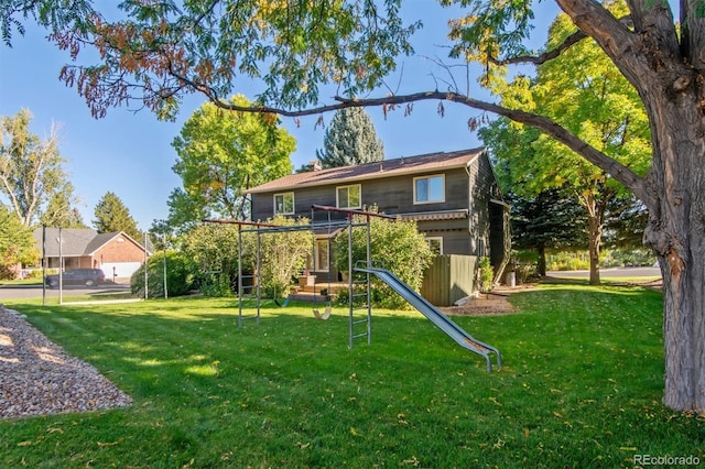 rear view of property with a lawn