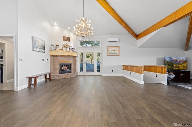 11039 Roxborough Dr, Littleton, CO 80125 - unfurnished living room featuring high vaulted ceiling, a wall unit AC, a chandelier, dark wood-style flooring, and a stone fireplace